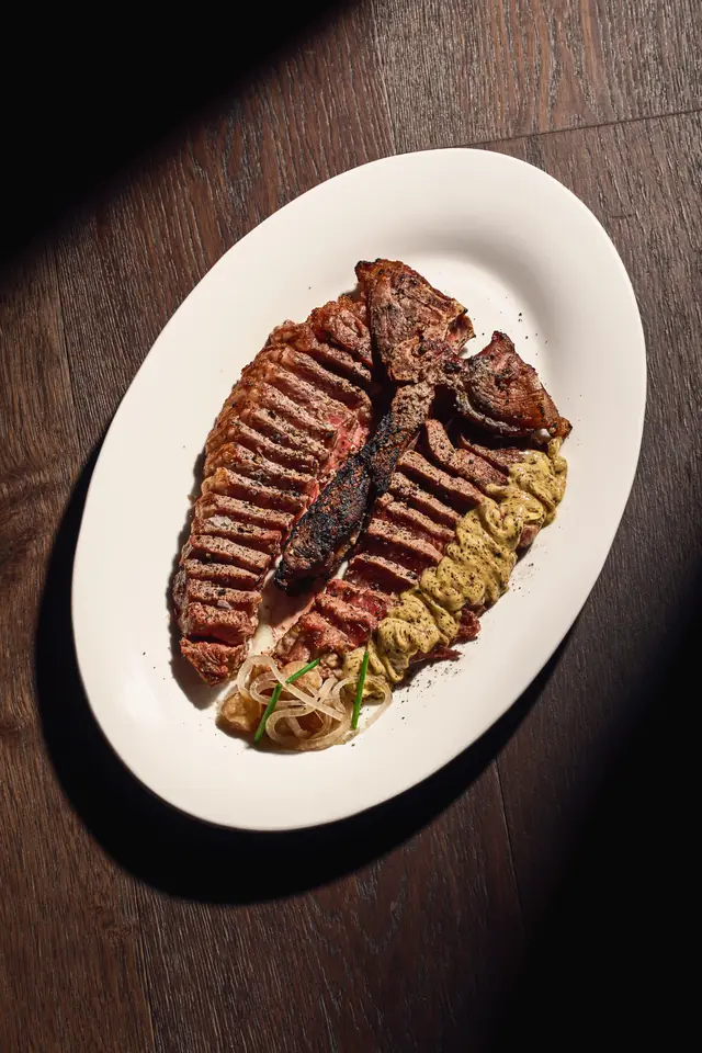 Dry-aged porterhouse on a white oval plate