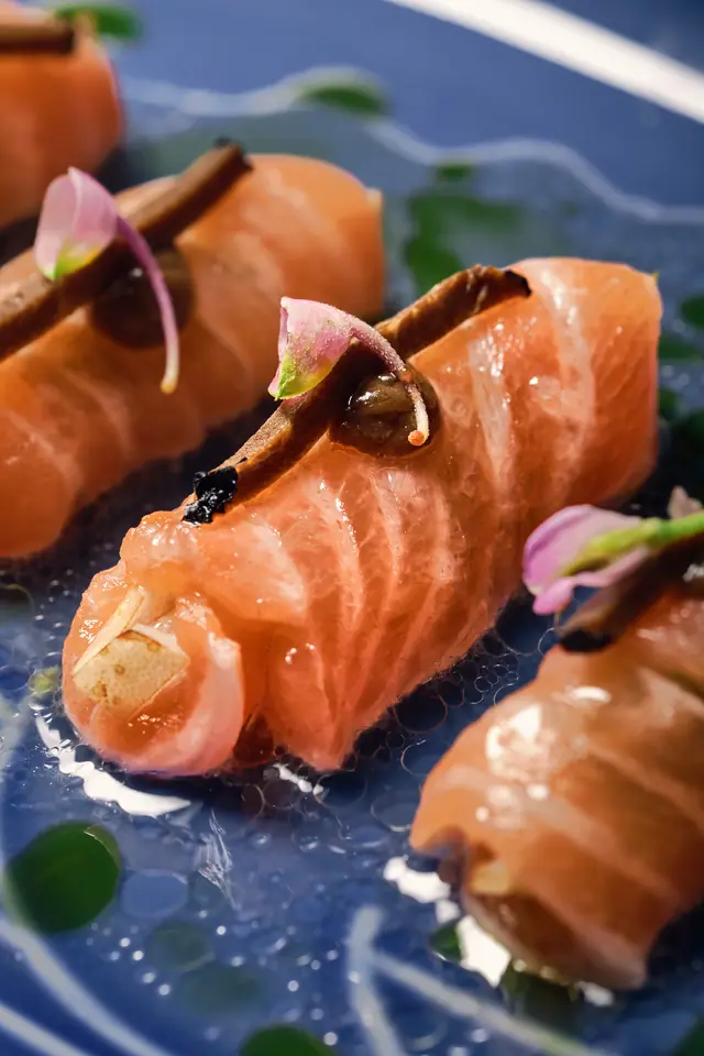 Salmon kilaw on a blue plate